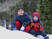Young Children Playing In The Snow