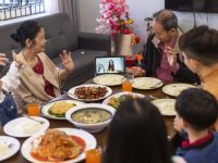 Family Having A Video Call During Reunion Dinner On Chinese New Year Eve